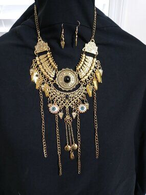 Gold Tone Gothic Bib Necklace w/ Eye & Coffin Charms – Statement Piece